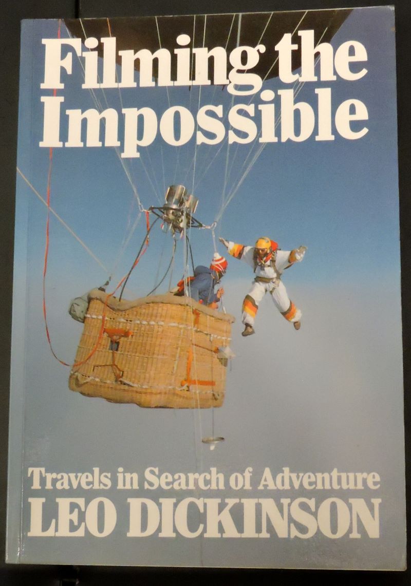 Picture of colour pictorial dust jacket showing a basket suspended from a hot air balloon at altitude with the author leaping out before skydiving